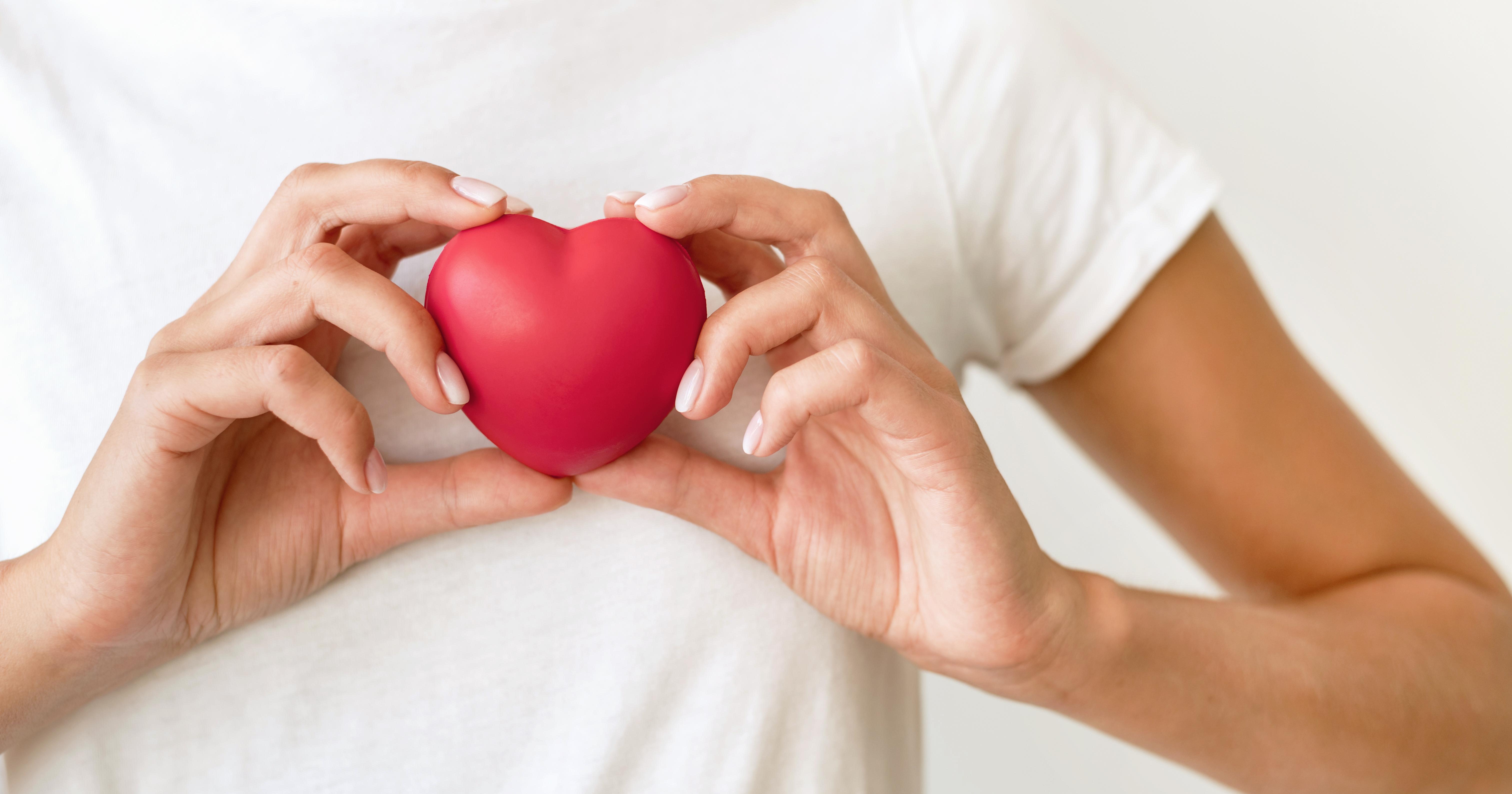 front-view-woman-holding-heart-shape.jpg